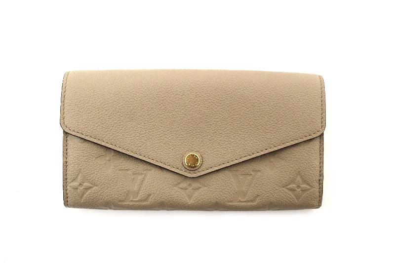 Louis Vuitton bags with a snap - button closure and a decorative charm for styleAuthentic Louis Vuitton Touterelle Beige Monogram Empreinte Leather Sarah Wallet